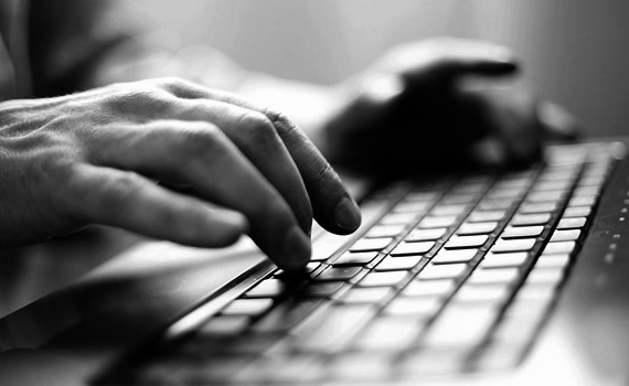 Man Typing on Keyboard